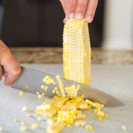Corn being cut off of the cob.
