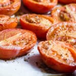 Roasted tomato halves in a baking pan.