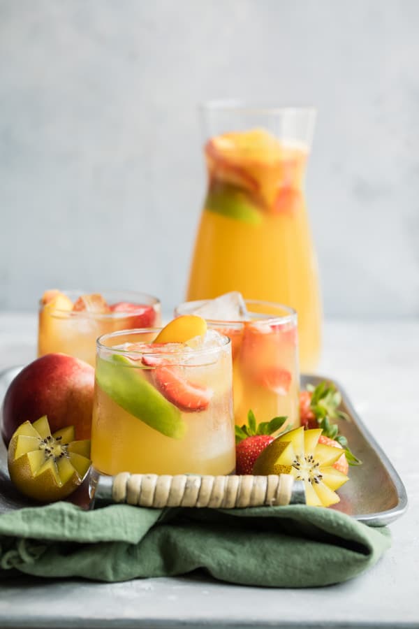 Passion Fruit and Pineapple Sangria whisks you away to the tropics with one sweet sip. The perfect signature drink for your next party, shower, or brunch!