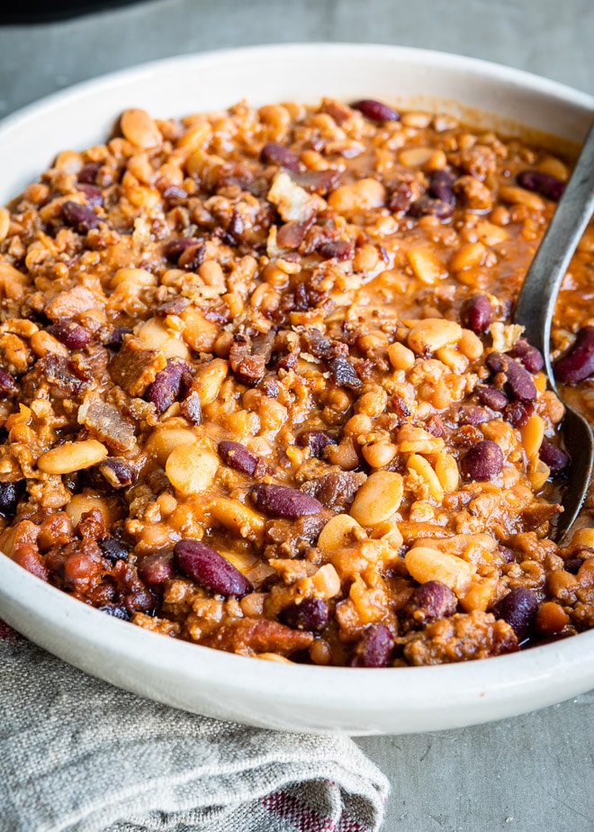 From cowboys to kiddos, everyone goes crazy for Slow Cooker Calico Beans. Loaded with beef and bacon, they're great for a cookouts, parties, and easy meals!