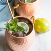 The best Moscow mule in a copper mug with a lime.