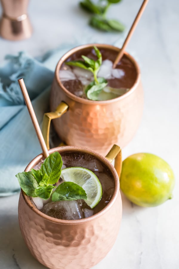 The best Moscow mule in two copper mugs with copper straws.