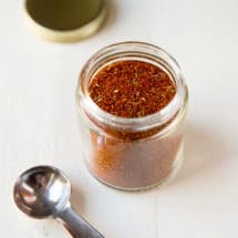 Homemade chili seasoning in a glass jar.