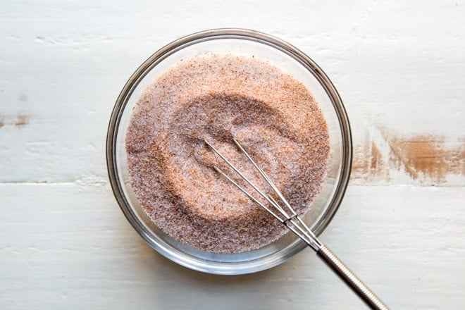 Lawrys seasoned salt in a clear dish with a small whisk.