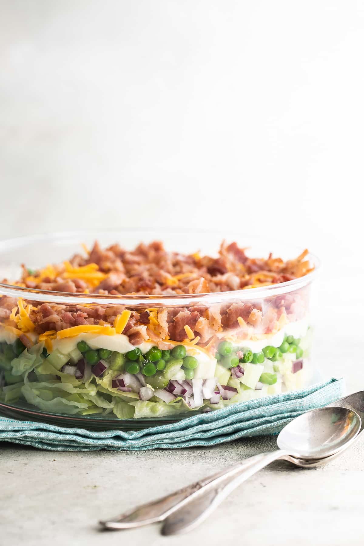 Seven layer salad in a glass dish.