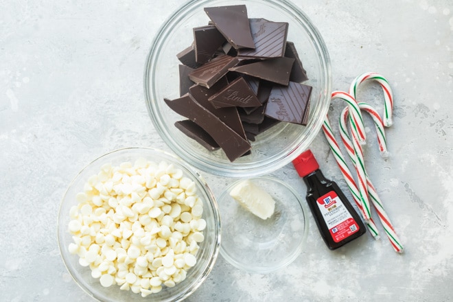 An overhead shot of peppermint bark ingredients in various bowls.