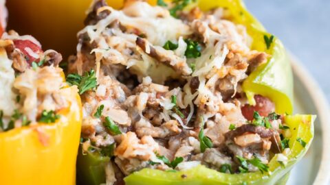 Stuffed bell peppers on a white platter.