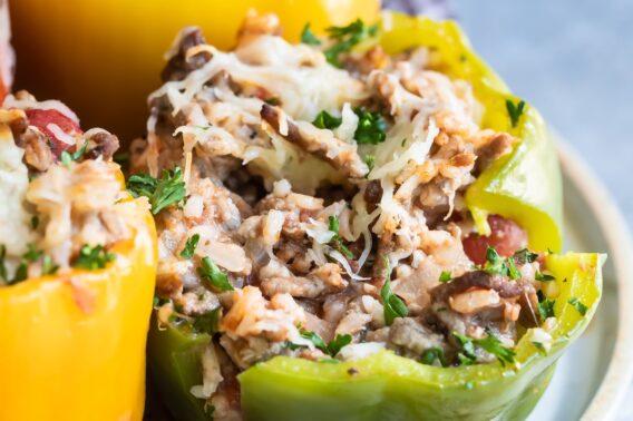 Stuffed bell peppers on a white platter.