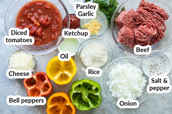 The ingredients for stuffed bell peppers arranged in bowls and labeled.