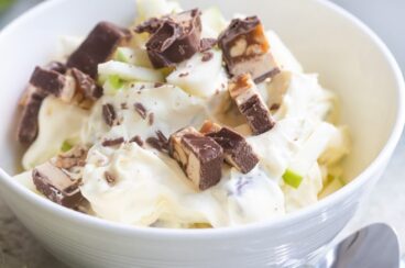 Snickers salad in a white bowl.