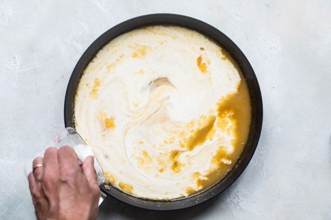Cream being added to Swedish meatball gravy.