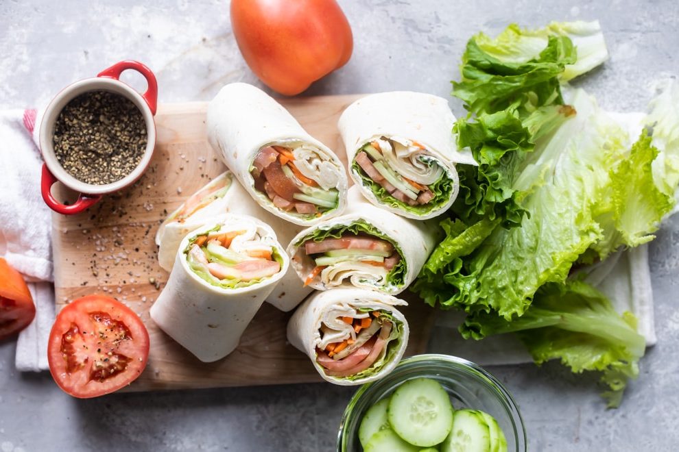 Ultimate veggie wraps on a wooden cutting board.