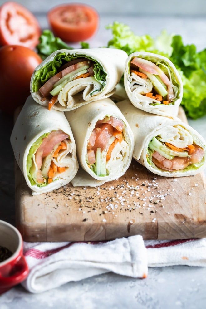 Ultimate veggie wraps on a wooden cutting board.