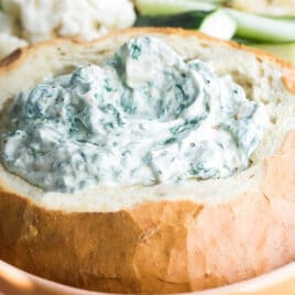 A bread bowl filled with Knorr Spinach Dip.