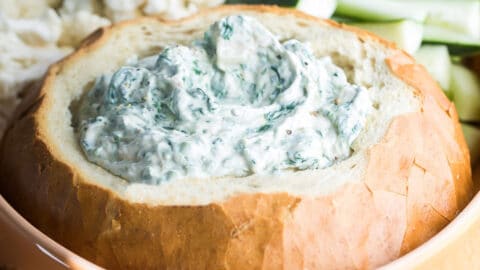 A bread bowl filled with Knorr Spinach Dip.