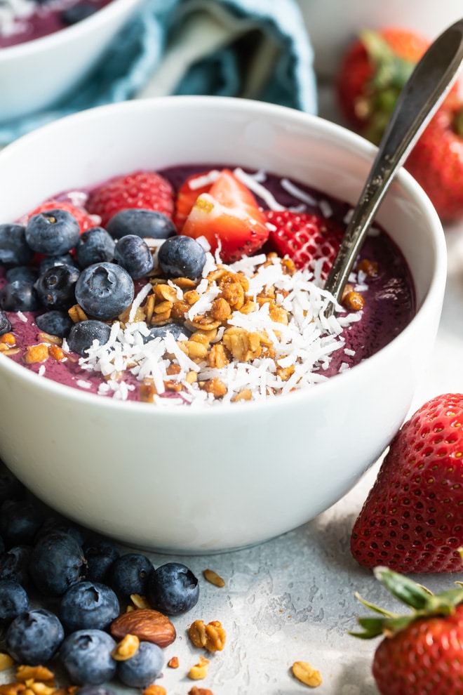 Easy acai bowl in a white dish with a spoon.