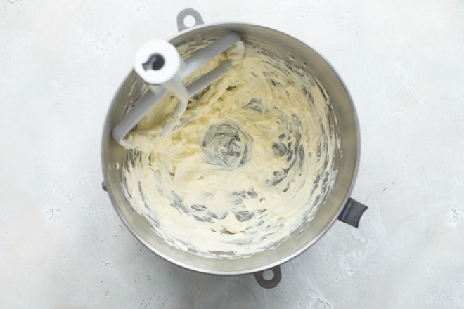 Creamed butter in a silver mixing bowl.