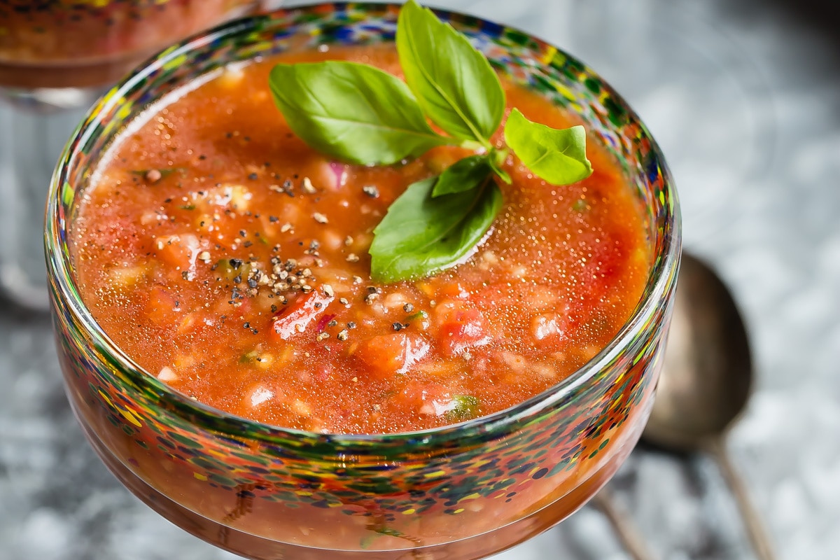A glass filled with gazpacho.