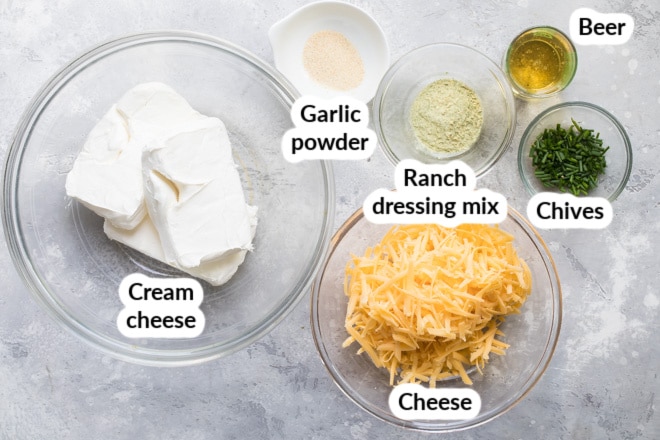 Labeled beer cheese dip ingredients in various bowls.
