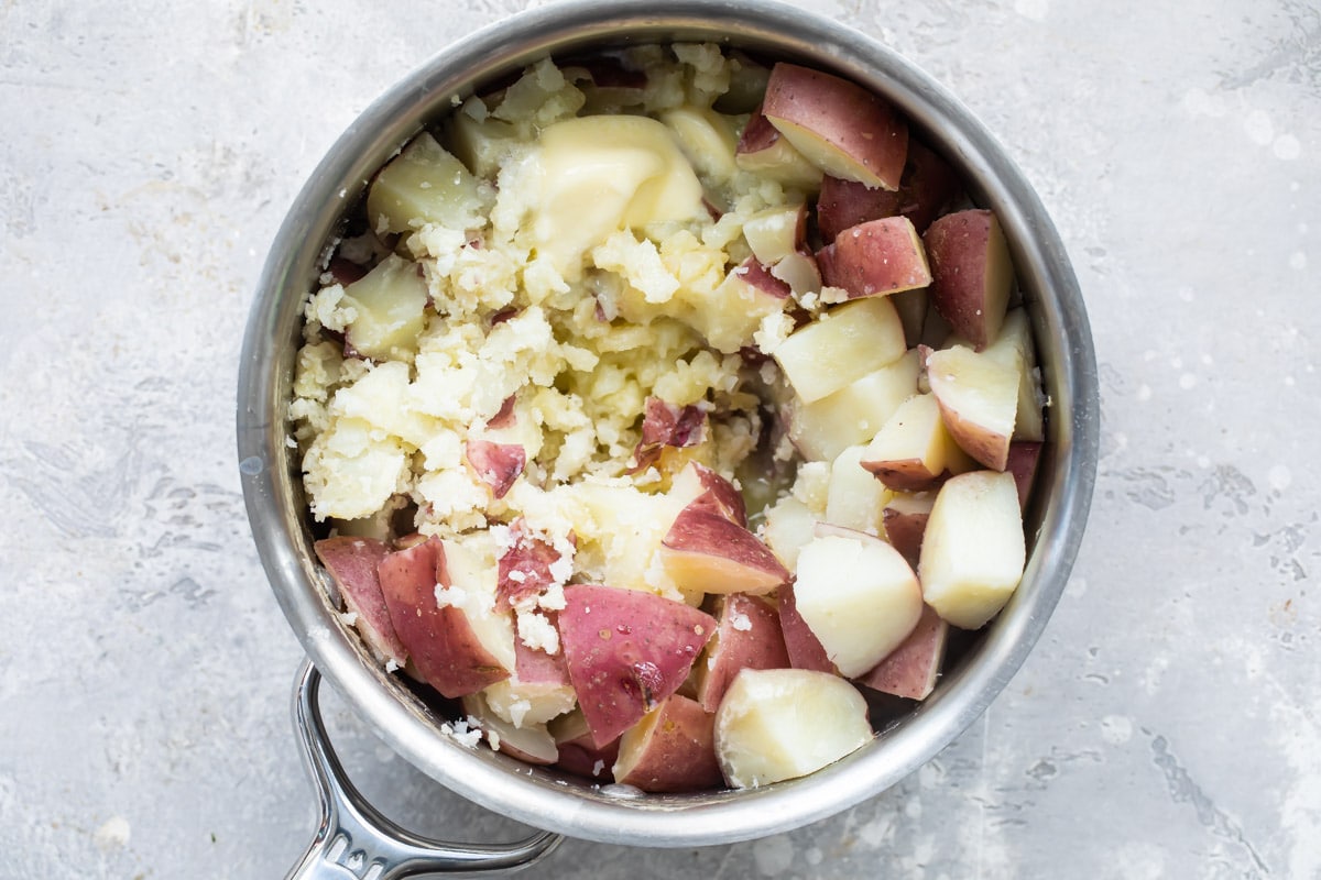 Boiled/cut potatoes in a pot with butter.