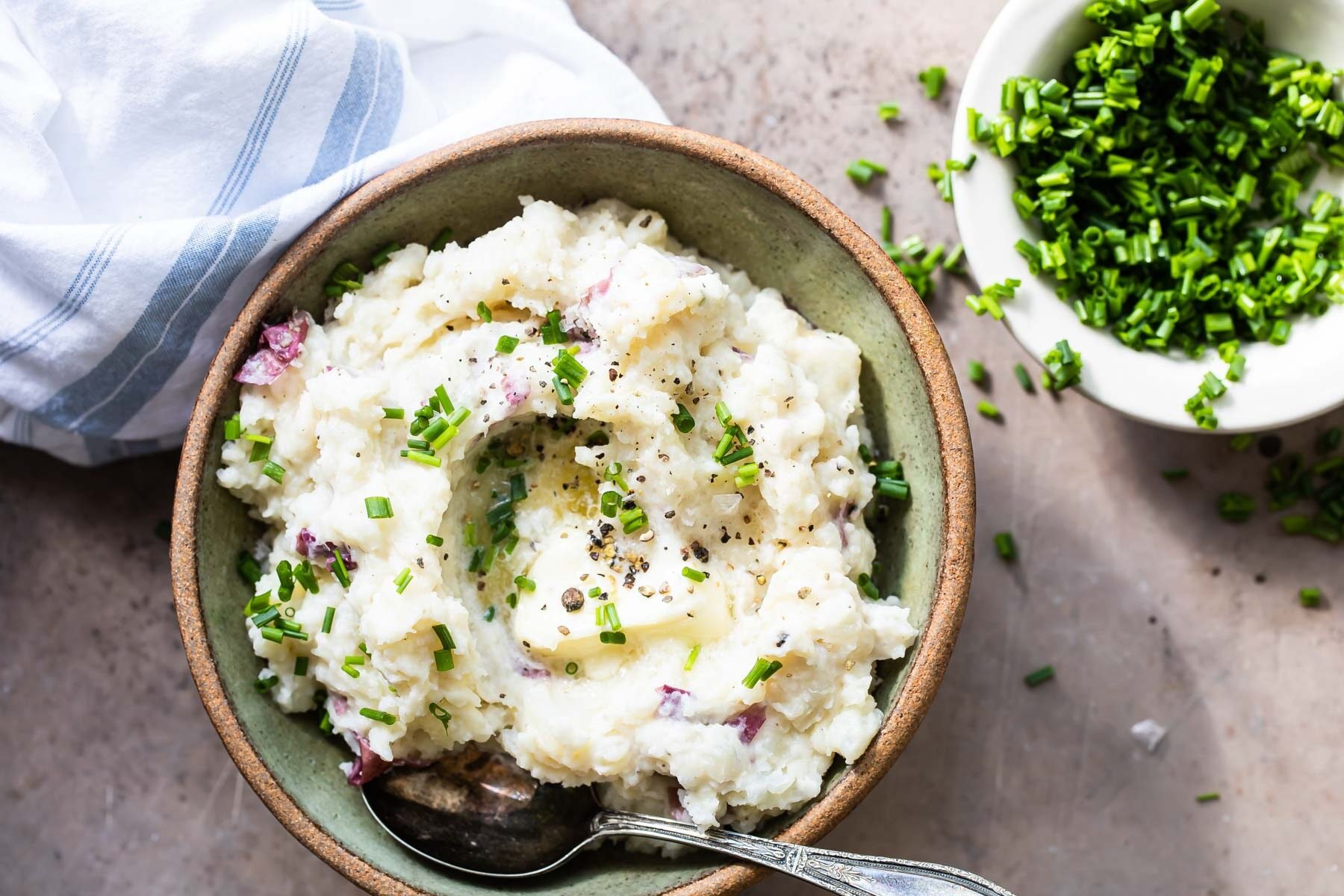 Boursin mashed potatoes in a light green bowl.