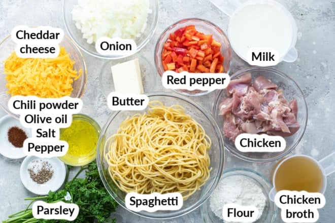 Labeled chicken spaghetti ingredients in various bowls.