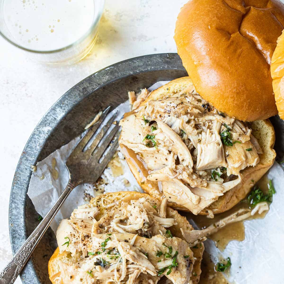 2 hot turkey sandwiches piled on a plate.