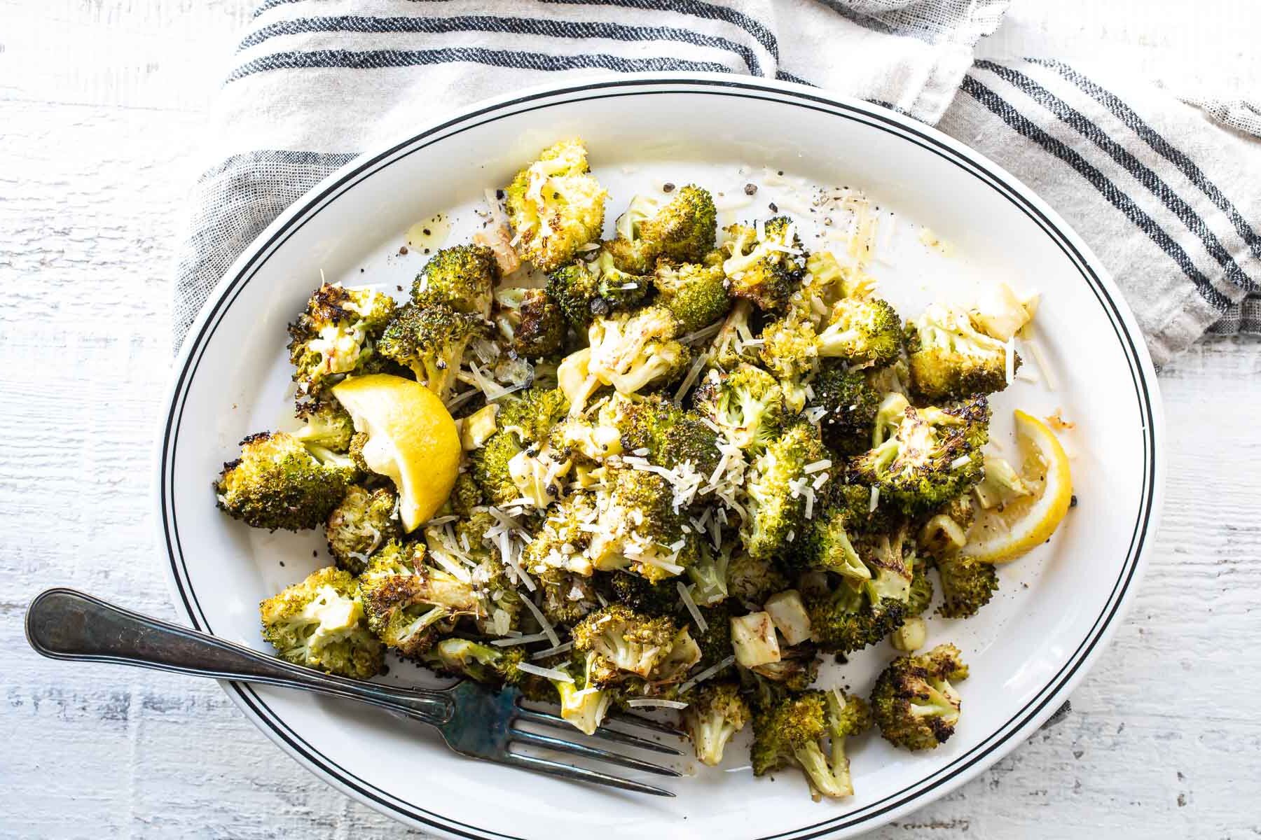 Roasted broccoli with lemon in a bowl.