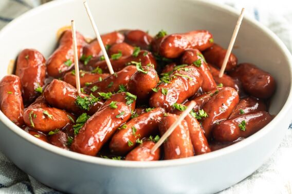 Barbecue little smokies in a white bowl.