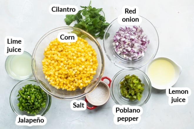 Labeled chipotle corn salsa ingredients in various bowls.