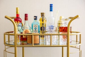 The top tier of a stocked bar cart.