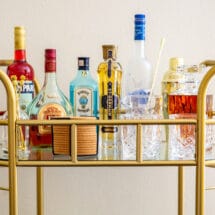 The top tier of a stocked bar cart.