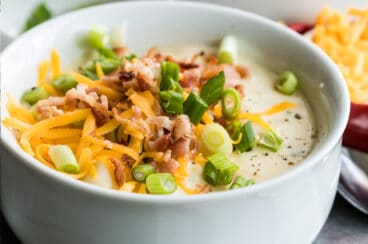Loaded baked potato soup in a white bowl.