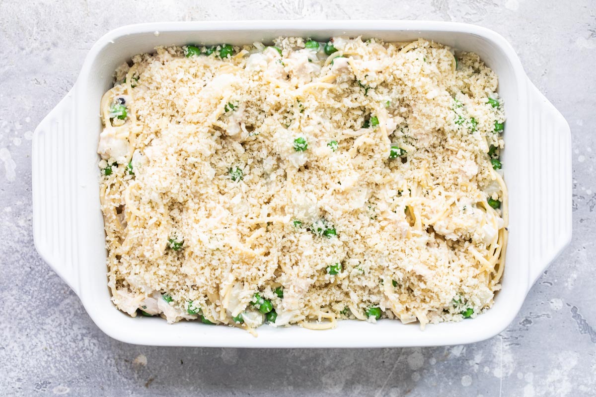 Turkey tetrazzini in a white baking dish before being cooked.