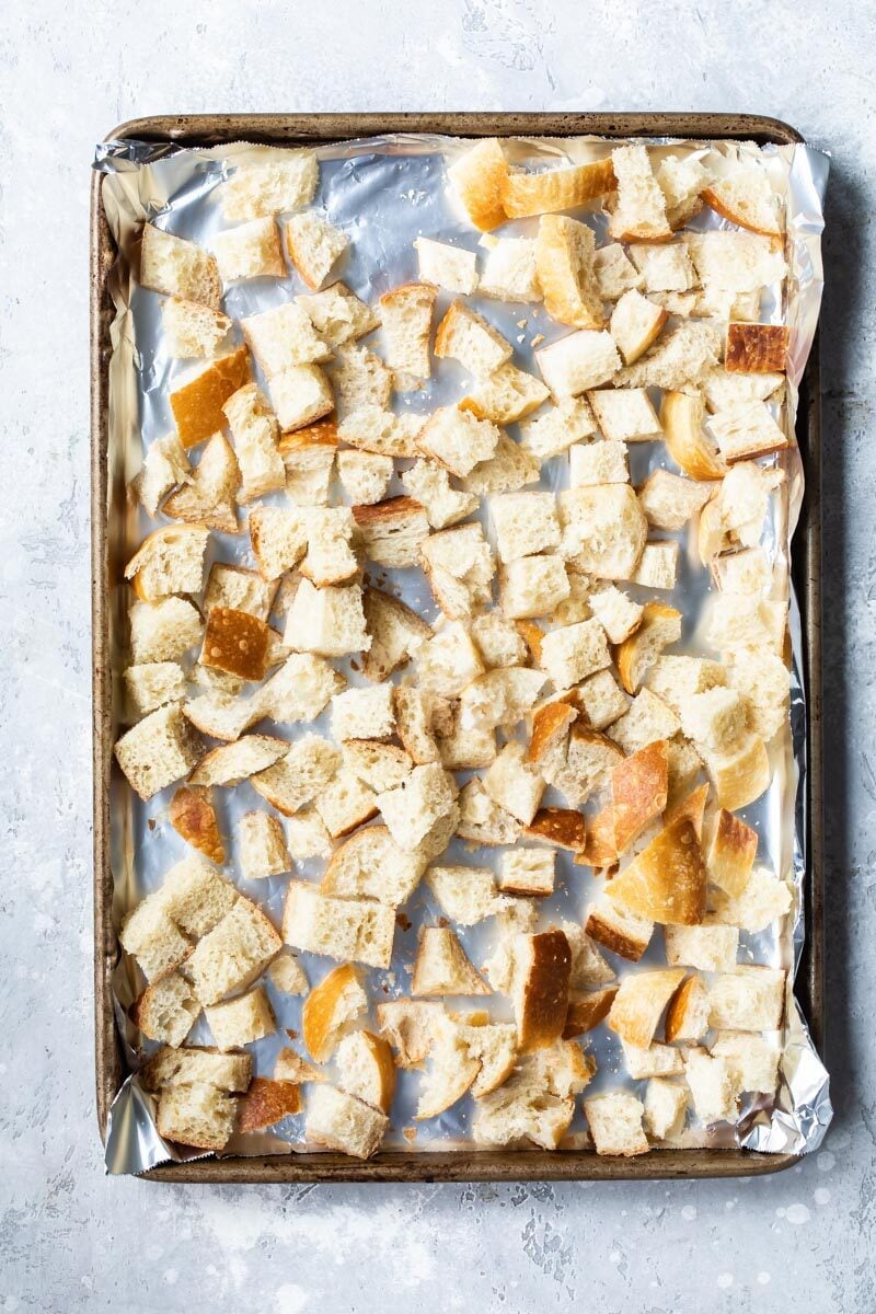 Cubes of bread on a baking sheet to try out for stuffing.