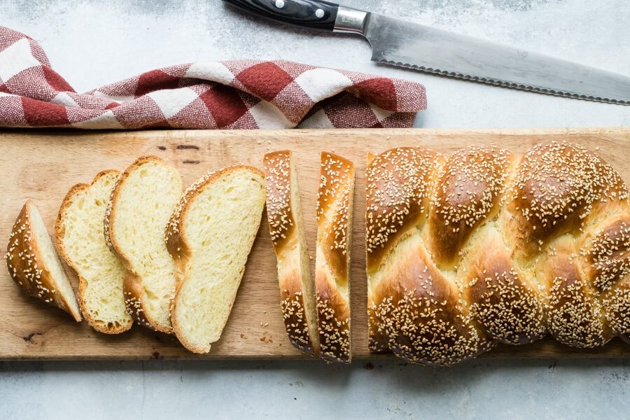 A loaf of Challah bread with a few slices cut off.
