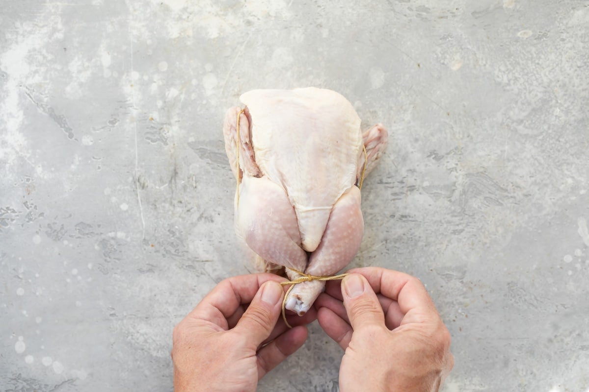 A Cornish hen being trussed.