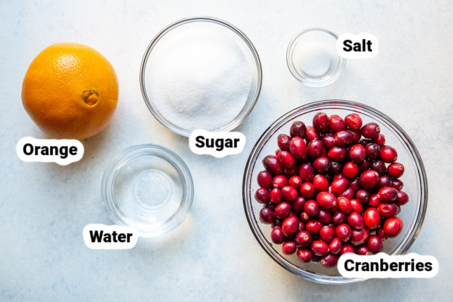 Ingredients for Cranberry Sauce in bowls and labeled.