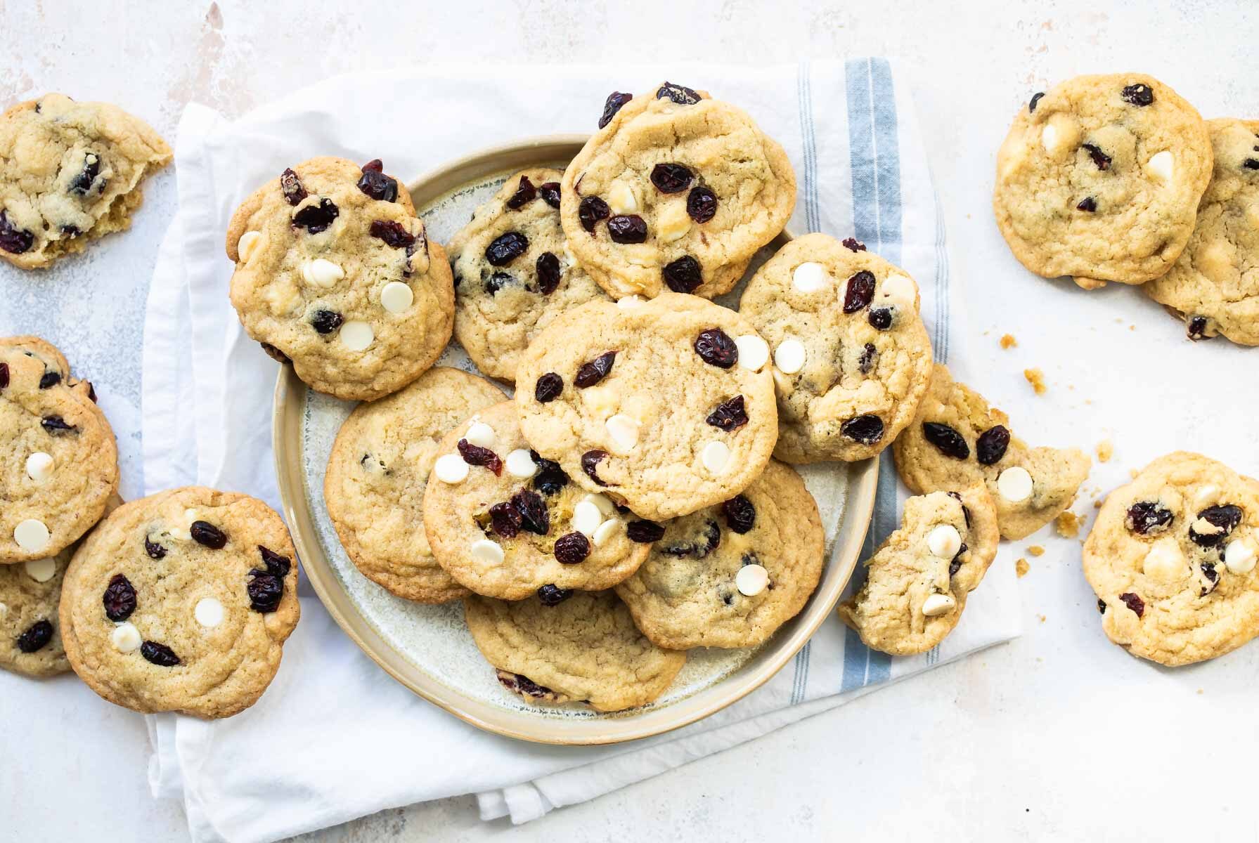 Cranberry cookies with white chocolate on a gray plate.