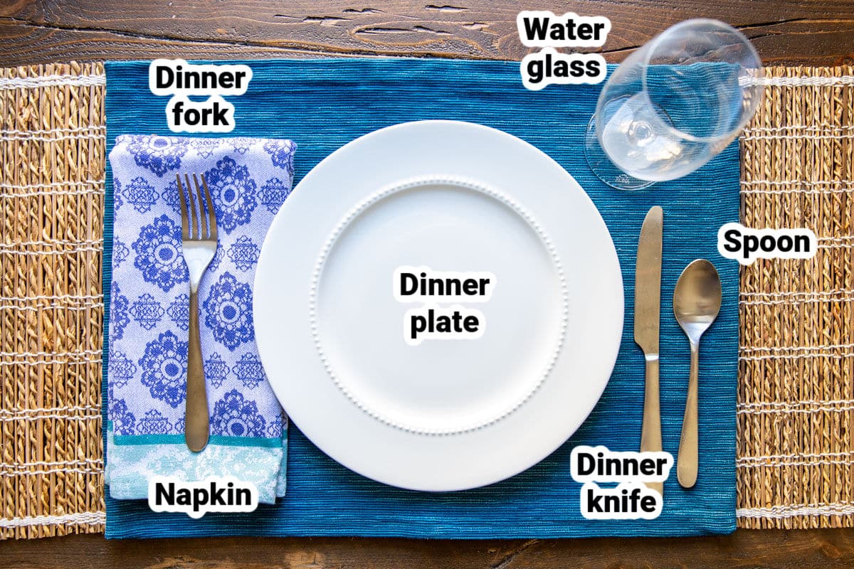 A basic table set with bone china, silverware, and glassware.