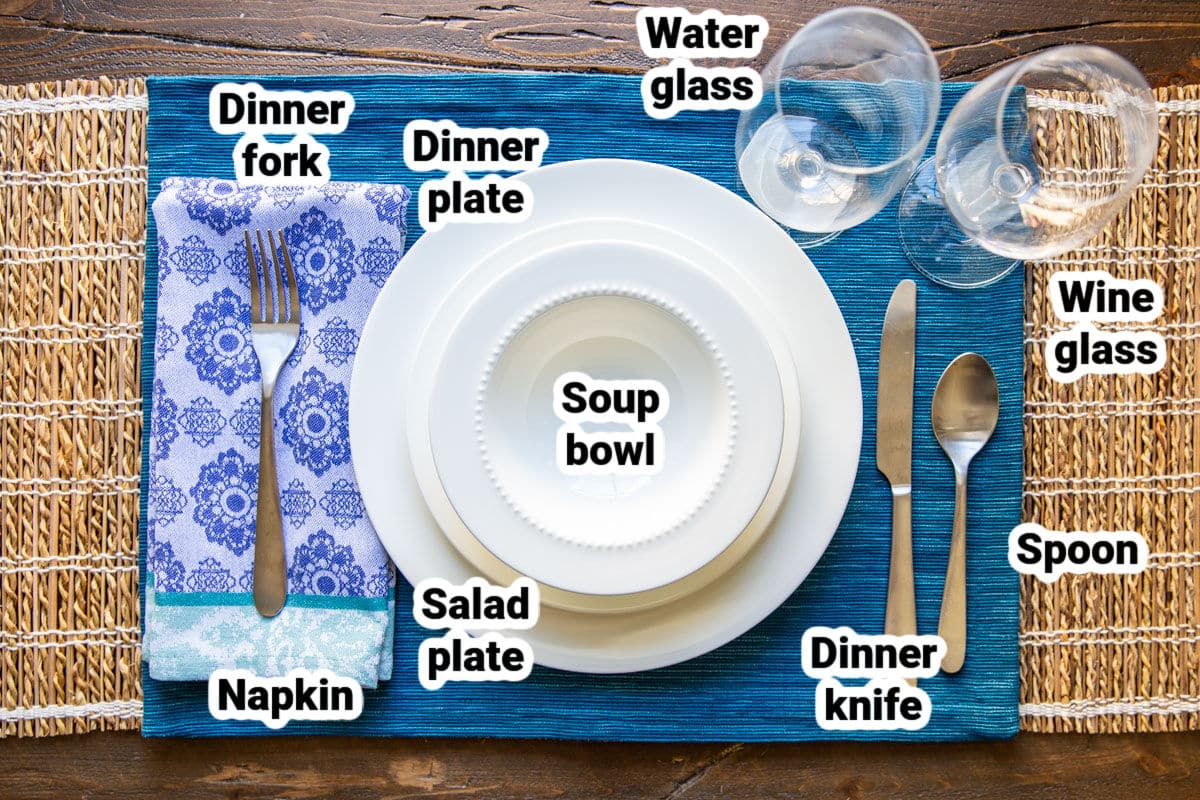 A casual table set with bone china, silverware, and glassware.