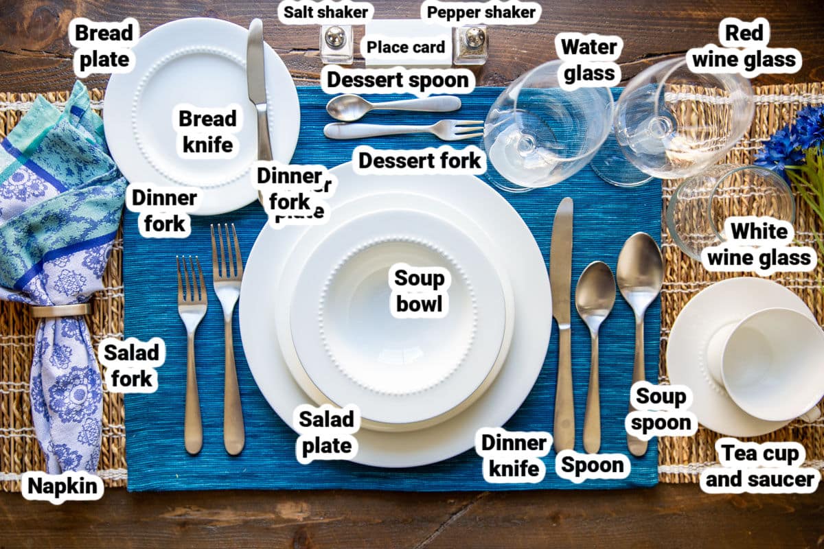 A formal table set with bone china, silverware, and glassware.