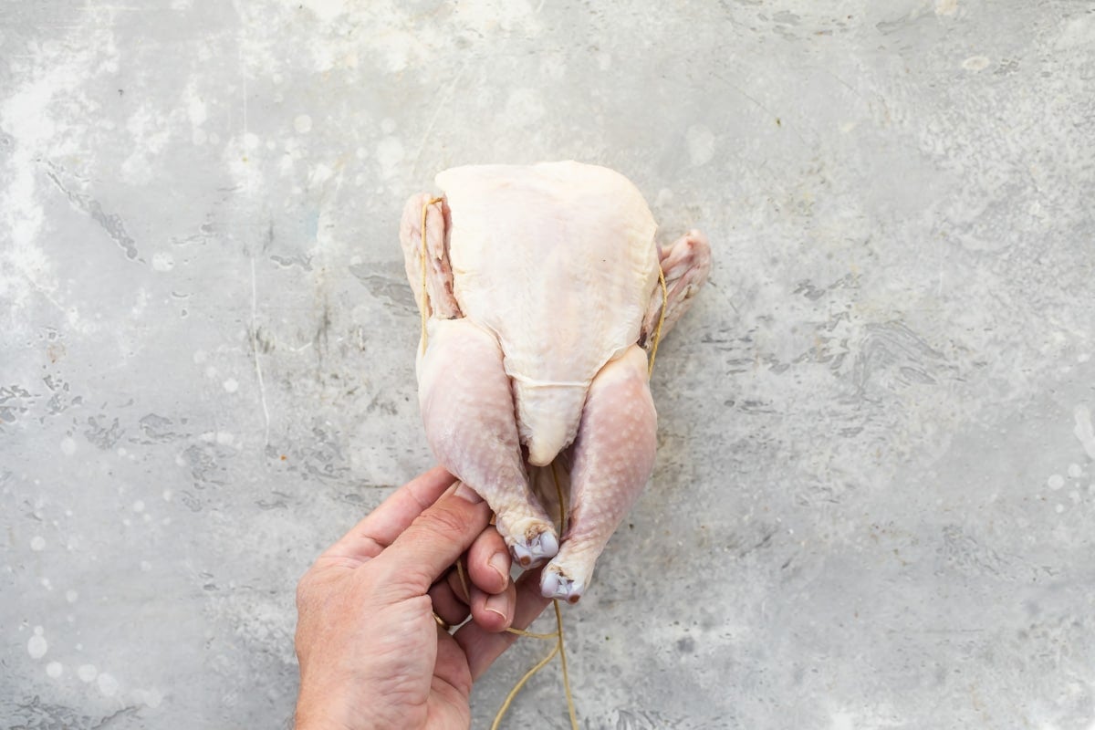 A Cornish hen being trussed.