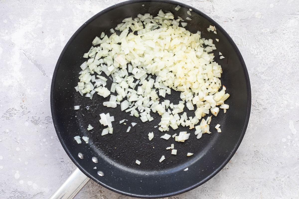 Cooked onion in a black skillet.