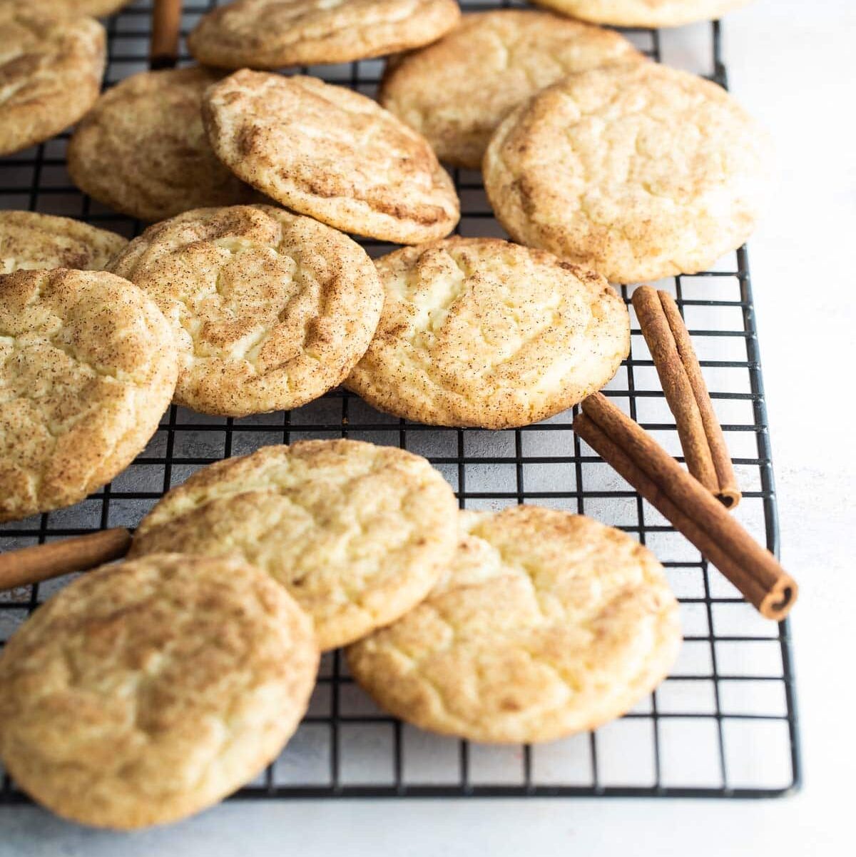 Snickerdoodle cookies on a baking rack.
