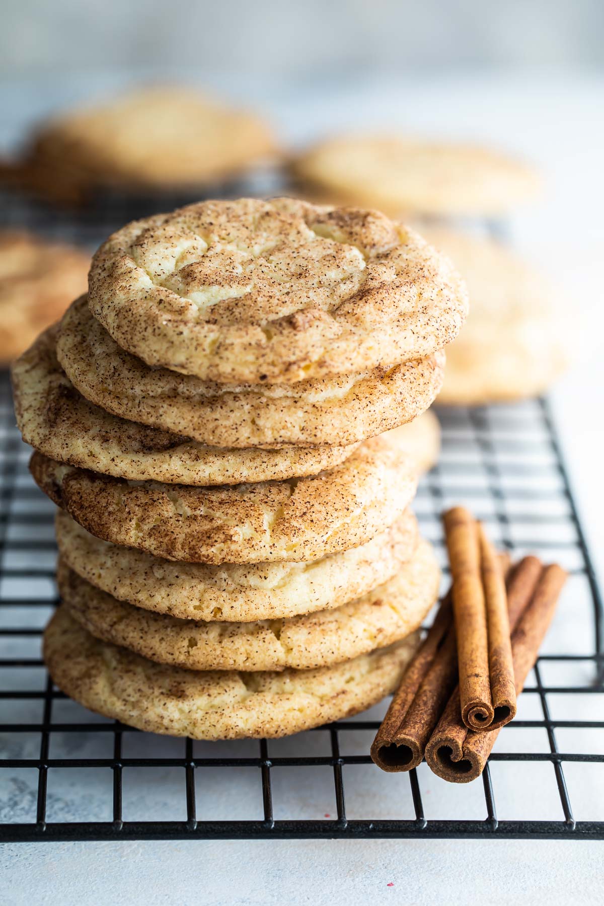 A stack of Snickerdoodle cookies on a baking rack.