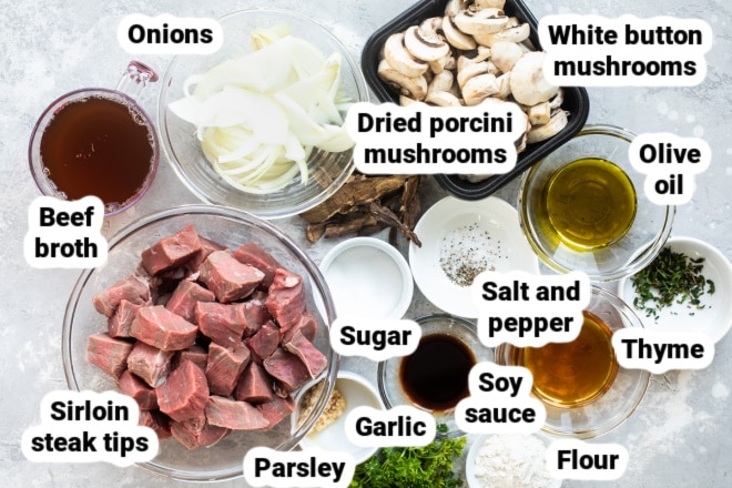 Steak tips with mushroom gravy ingredients in various bowls.