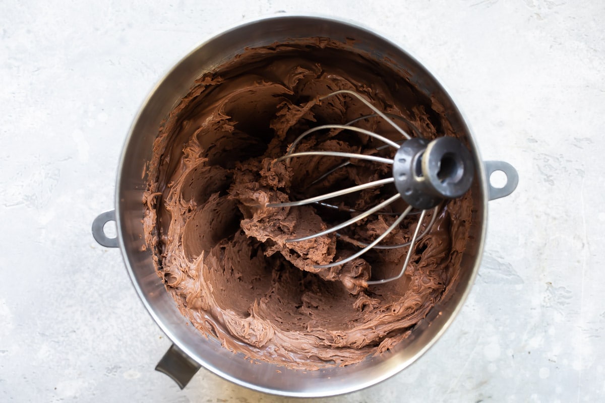 Whipped chocolate ganache in a mixing bowl.