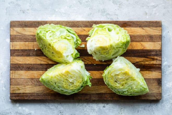 A head of iceberg lettuce cut into 4 wedges.
