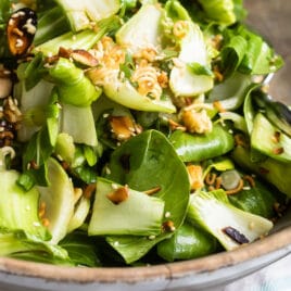 Baby bok choy salad in a wooden bowl.